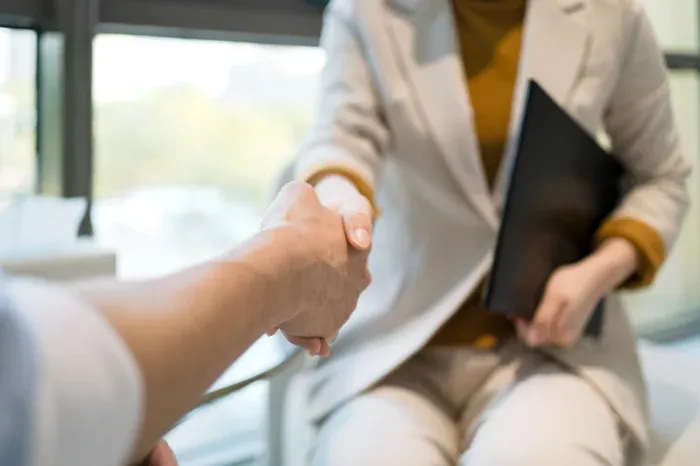 Close up shot of two people shaking hands