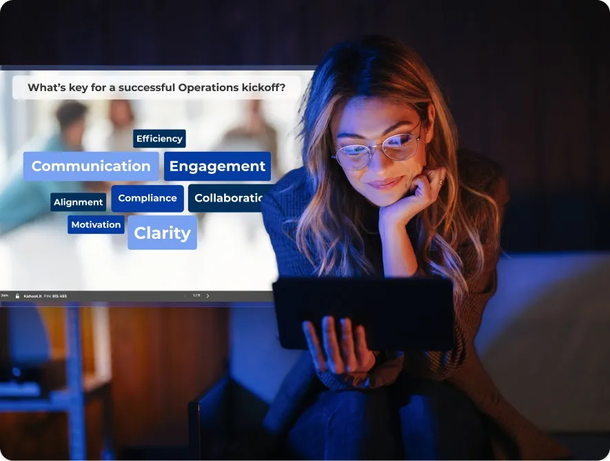 A woman wearing glasses smiles while looking at a tablet in a dimly lit room. There is an overlaid Kahoot! Wordcloud on her right.