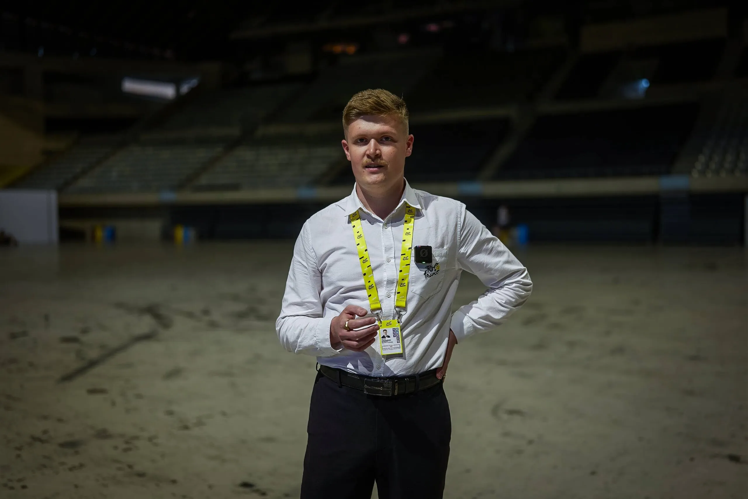 A picture of Arthur Chouanniere, Partner Relations at Amaury Sports Organization (A.S.O.) in an empty arena.