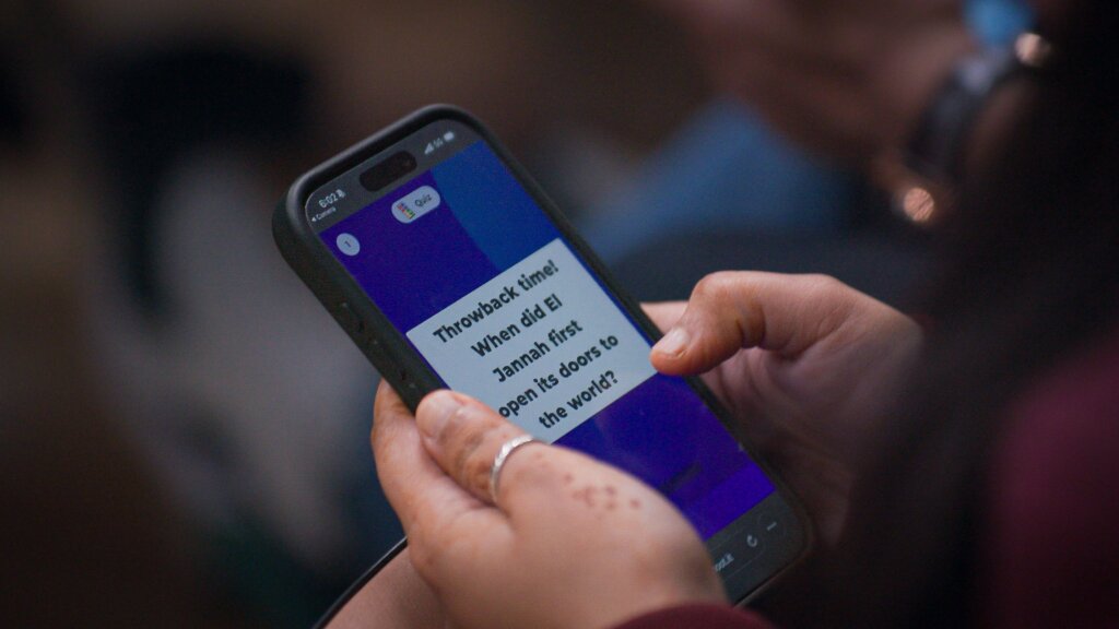 Phone screen showing Kahoot! 360 user interface on the hands of El Jannah employee