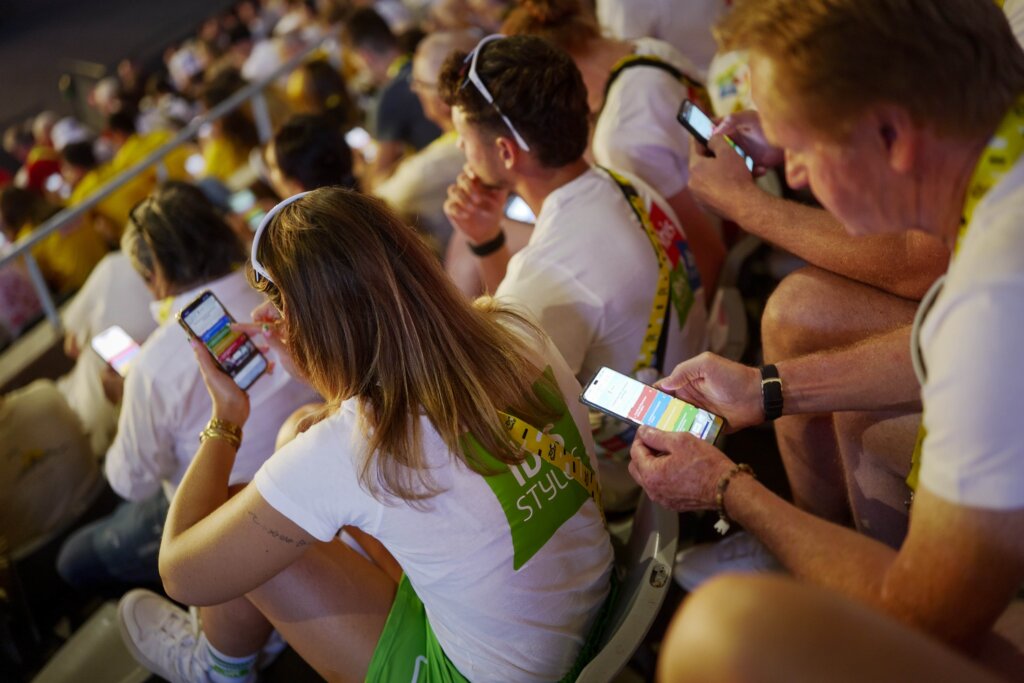 Members in the audience are using their mobile phones responding to Kahoot! questions. These are team members of the caravans at Tour de France.